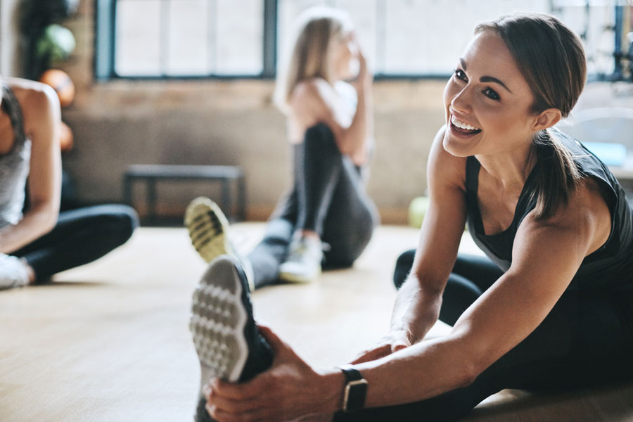 young woman stretching at a gym after visiting the wellness center in McAllen