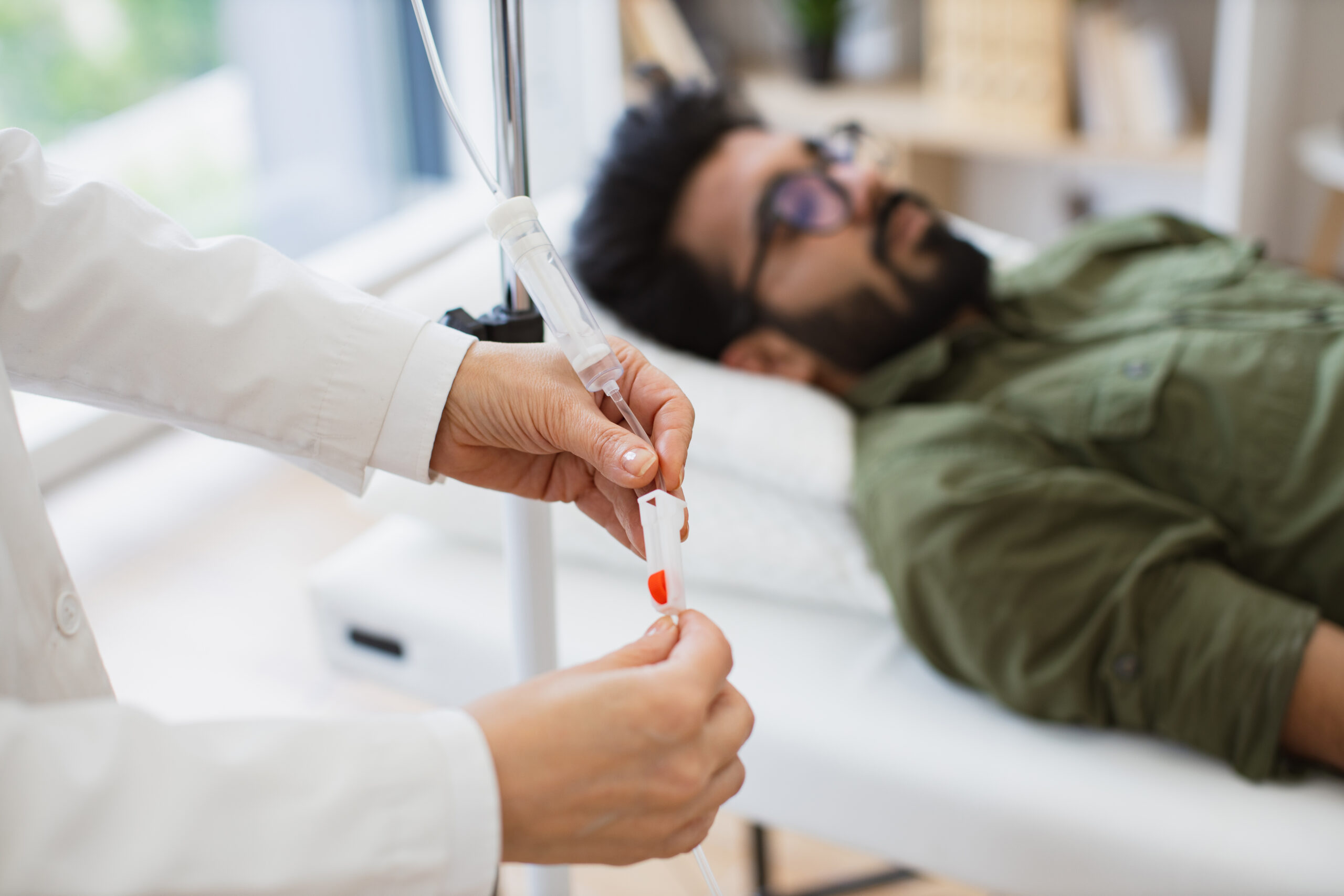 A medical professional giving a man a wellness IV drip